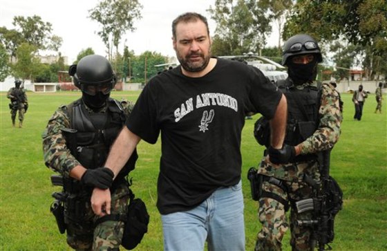 Navy marines escort Sergio Villarreal Barragan after his arrest in Puebla, Mexico, on Sunday.